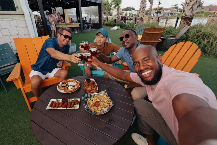 A group toasting after the round
